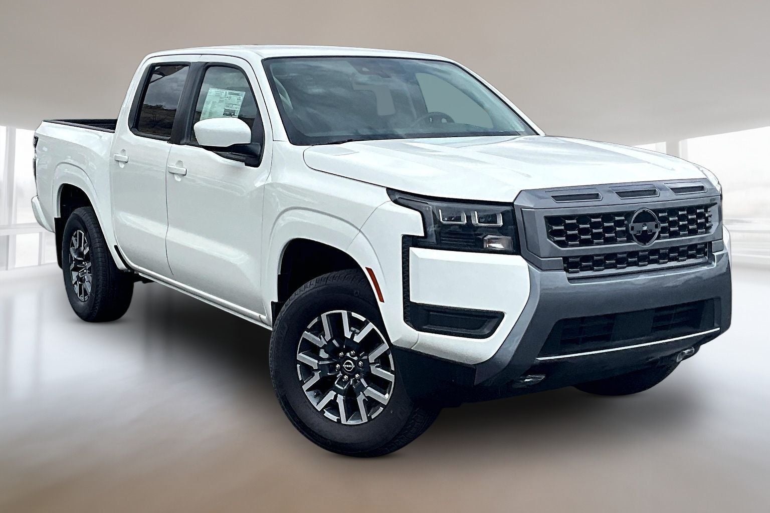 2026 Nissan Frontier Crew Cab SV in Glacier White — front three-quarter view