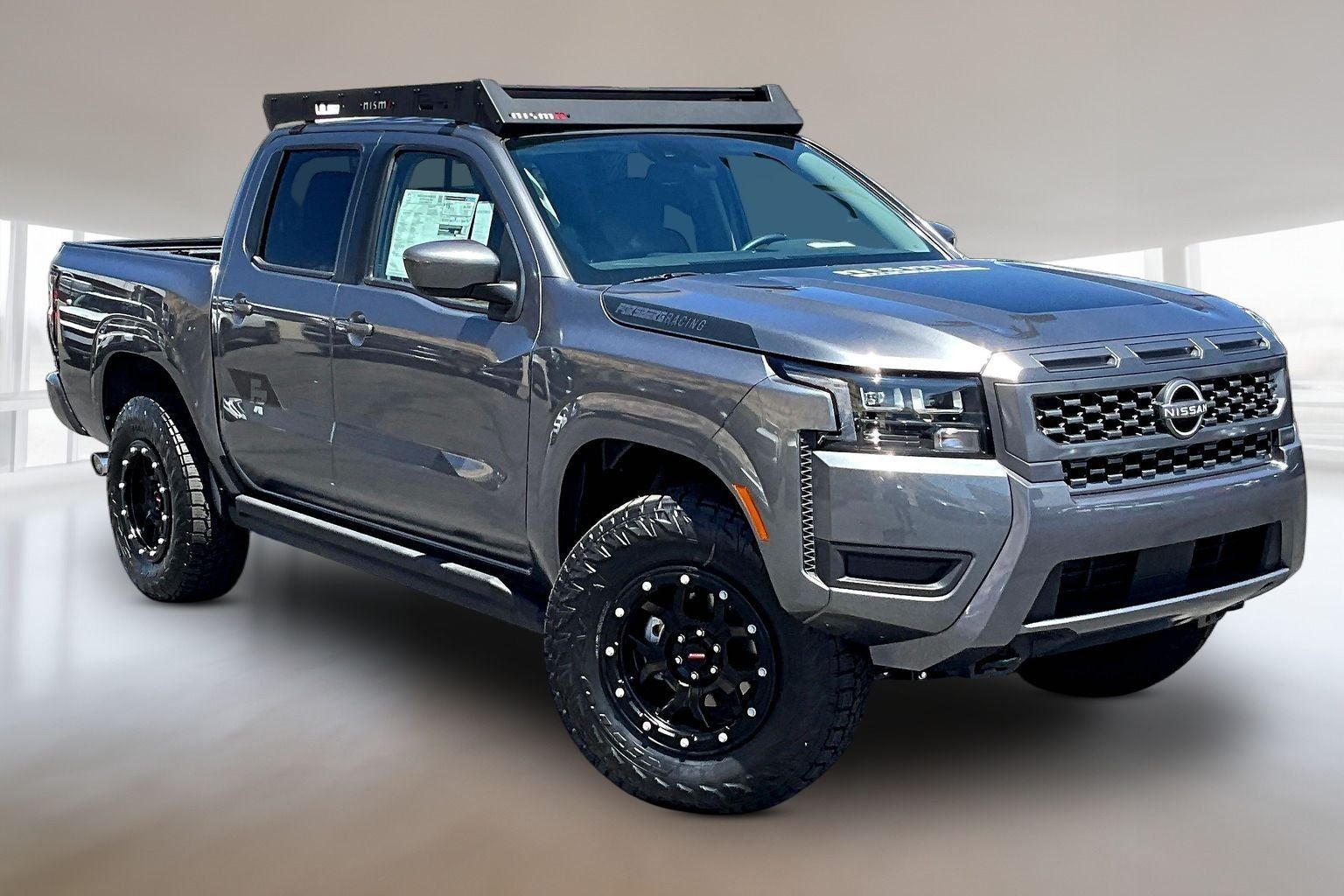 2026 Nissan Frontier Crew Cab SV in Gun Metallic — front three-quarter view
