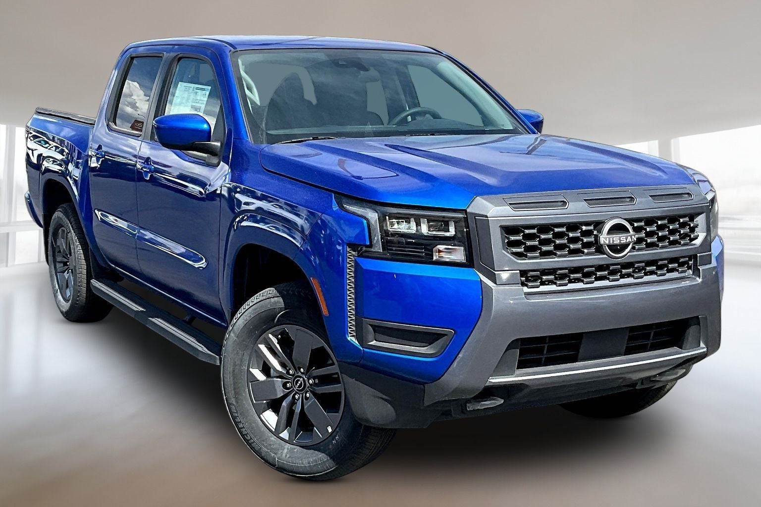 2026 Nissan Frontier Crew Cab SV in Bluestone — front three-quarter view