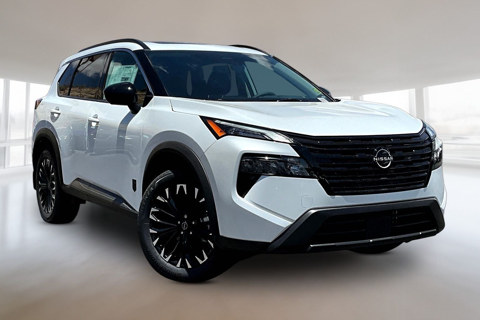 2026 Nissan Rogue Dark Armor in White Pearl — front three-quarter view